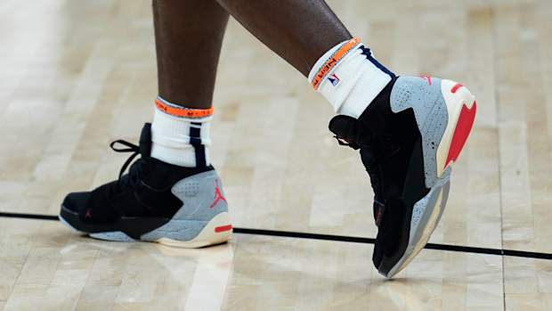 View of Zion Williamson's black, grey, and red Jordan sneakers.